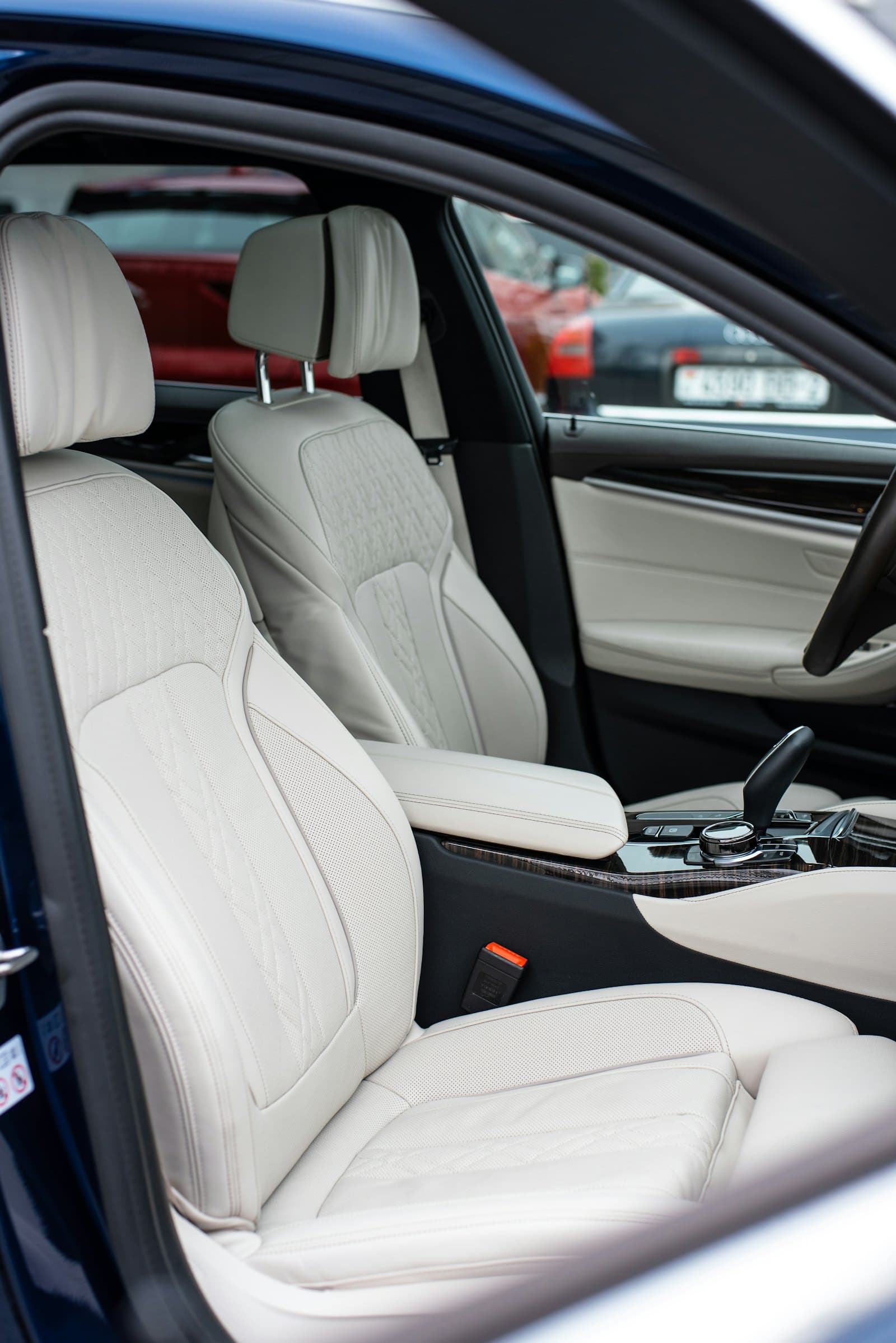 Cream leather seats inside an executive saloon, door open